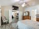 Spacious main bedroom with a high ceiling, ceiling fan, and wood-look flooring and furniture at 1516 Arrowhead Trl, Enterprise, FL 32725