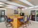 Outdoor wet bar with wood design including bar seating, sink and outdoor mini refrigerator at 1516 Arrowhead Trl, Enterprise, FL 32725