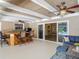 Outdoor entertaining space with kitchen/bar area and view of pool and indoor living area at 1516 Arrowhead Trl, Enterprise, FL 32725