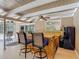 Relaxing covered patio with an outdoor bar area, featuring a sink, counter seating, and a ceiling fan at 1516 Arrowhead Trl, Enterprise, FL 32725