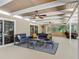Large covered patio with seating, ceiling fans, windows, and natural light at 1516 Arrowhead Trl, Enterprise, FL 32725