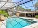 A refreshing pool in a screened enclosure with a patio, perfect for outdoor entertaining and relaxation at 1516 Arrowhead Trl, Enterprise, FL 32725
