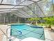 Enjoy a refreshing swim in your private screened-in pool surrounded by lush greenery and sunlight at 1516 Arrowhead Trl, Enterprise, FL 32725