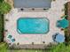 Top-down view of a backyard featuring a pool, brick patio, umbrellas, and outdoor seating at 1555 Mercers Fernery Rd, Deland, FL 32720