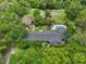Aerial view featuring a pool, lush landscaping, and a well-maintained brick home at 1555 Mercers Fernery Rd, Deland, FL 32720