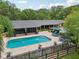 Aerial view of a home showcasing the pool, patio, screened-in porch, and well-maintained backyard at 1555 Mercers Fernery Rd, Deland, FL 32720