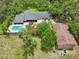 Aerial view showcasing a pool and outbuilding on this expansive property at 1555 Mercers Fernery Rd, Deland, FL 32720