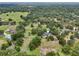 Extensive aerial view showcasing a property with a house, pool, and wooded surroundings at 1555 Mercers Fernery Rd, Deland, FL 32720