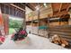 Barn interior with wooden beams, lattice work, and a lawn mower parked inside at 1555 Mercers Fernery Rd, Deland, FL 32720
