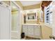 Well-lit bathroom features a white vanity with a large mirror and a shower with a sliding door at 1555 Mercers Fernery Rd, Deland, FL 32720