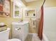 Bathroom with vanity, toilet, framed mirror, and shower with red striped shower curtain at 1555 Mercers Fernery Rd, Deland, FL 32720