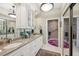 Bright bathroom with double vanity featuring granite counters, stylish mirrors, and a walk-in shower at 1555 Mercers Fernery Rd, Deland, FL 32720