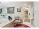 Bathroom featuring a large soaking tub, stylish fixtures, and decorative accents at 1555 Mercers Fernery Rd, Deland, FL 32720