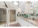 Bathroom featuring double sinks, granite counters, mirrored cabinets, and tile flooring at 1555 Mercers Fernery Rd, Deland, FL 32720