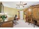 Bedroom with carpet, ceiling fan, lamp, desk, and an armoire at 1555 Mercers Fernery Rd, Deland, FL 32720