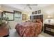 Well-lit bedroom with a queen-sized bed, decorative pillows, and a ceiling fan at 1555 Mercers Fernery Rd, Deland, FL 32720