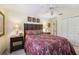 Bedroom featuring tropical bedding, a ceiling fan, and decorative lamps on side tables at 1555 Mercers Fernery Rd, Deland, FL 32720