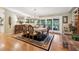 Formal dining room with ornate table, brick fireplace, and access to outdoor patio at 1555 Mercers Fernery Rd, Deland, FL 32720