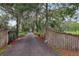 Long driveway approaching the home from an entrance gate at 1555 Mercers Fernery Rd, Deland, FL 32720