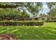 Beautiful front yard showcasing meticulous landscaping and a well-maintained brick home at 1555 Mercers Fernery Rd, Deland, FL 32720