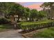 Quaint front yard with manicured hedges, mature trees, and exterior home details at 1555 Mercers Fernery Rd, Deland, FL 32720