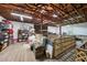 Spacious storage with exposed wood beams, shelves, and a variety of items for practical and organized living at 1555 Mercers Fernery Rd, Deland, FL 32720