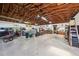 Spacious garage interior with ample storage, work area, and covered car, perfect for hobbyists at 1555 Mercers Fernery Rd, Deland, FL 32720