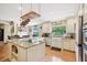 Bright kitchen featuring granite countertops, stainless steel appliances, and hardwood floors at 1555 Mercers Fernery Rd, Deland, FL 32720
