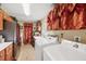 Convenient laundry room with wooden cabinets, countertop, stainless fridge, and tile flooring at 1555 Mercers Fernery Rd, Deland, FL 32720