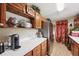 Cherrywood cabinets with countertop, stainless fridge, and tile flooring in the laundry room at 1555 Mercers Fernery Rd, Deland, FL 32720