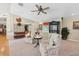 Cozy living room with matching chairs, ceiling fan, and natural light from the window view at 1555 Mercers Fernery Rd, Deland, FL 32720