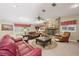 Cozy living room with stone fireplace, comfortable sofas, and large windows at 1555 Mercers Fernery Rd, Deland, FL 32720