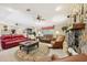 Warm and inviting living room featuring a stone fireplace and comfortable seating at 1555 Mercers Fernery Rd, Deland, FL 32720