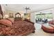 Large main bedroom with patio access, ceiling fan, and hardwood furniture at 1555 Mercers Fernery Rd, Deland, FL 32720