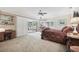 Spacious main bedroom featuring a ceiling fan, desk, and access to the enclosed patio at 1555 Mercers Fernery Rd, Deland, FL 32720