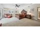 Spacious main bedroom featuring a ceiling fan and an ornate wooden bed frame with side tables at 1555 Mercers Fernery Rd, Deland, FL 32720