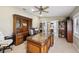 Spacious office featuring hardwood furniture, ceiling fan, and natural lighting from the window at 1555 Mercers Fernery Rd, Deland, FL 32720
