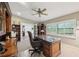 Bright office space with large windows, ceiling fan, and custom hardwood office furniture at 1555 Mercers Fernery Rd, Deland, FL 32720