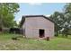 Outbuilding features a sliding door and an open interior at 1555 Mercers Fernery Rd, Deland, FL 32720