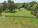 Fenced pasture with a large, grassy field, perfect for animals or recreation at 1555 Mercers Fernery Rd, Deland, FL 32720