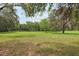 A large pasture framed by trees and a fence creates an inviting rural scene at 1555 Mercers Fernery Rd, Deland, FL 32720