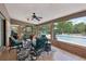 Covered patio has dark teal patio set, view of the pool and backyard at 1555 Mercers Fernery Rd, Deland, FL 32720