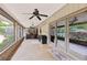 Covered patio featuring seating, ceiling fan, tile flooring, and view of pool and backyard at 1555 Mercers Fernery Rd, Deland, FL 32720