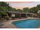 Beautiful pool with brick patio, fountains, and screened-in porch, perfect for outdoor relaxation and entertaining at 1555 Mercers Fernery Rd, Deland, FL 32720