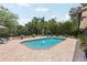 Inviting pool area with a brick patio, fountains, and well-manicured landscaping, perfect for outdoor enjoyment at 1555 Mercers Fernery Rd, Deland, FL 32720