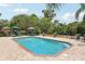 Sparkling pool with brick surround, fountains, and lounge chairs, perfect for enjoying sunny days outdoors at 1555 Mercers Fernery Rd, Deland, FL 32720