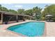 Lovely backyard featuring a sparkling pool with fountains, brick patio, and outdoor seating at 1555 Mercers Fernery Rd, Deland, FL 32720