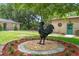 Yard with a rooster statue as a focal point, complimented by manicured landscaping in this well maintained home at 1555 Mercers Fernery Rd, Deland, FL 32720