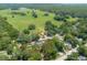 Captured from above, this image displays a property with surrounding greenery and an open field nearby at 1620 20Th St, Orange City, FL 32763