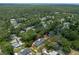 A stunning aerial shot showcases a verdant neighborhood with tree-lined streets and a home with a private yard and pool at 1620 20Th St, Orange City, FL 32763
